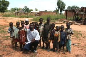 UC Davis collaborator Abou with children in Sidarebougou. Image courtesy of the Vector Genetics Lab at UC Davis.